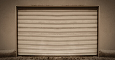 Old weathered and rusty closed steel door for steel metal store, storage of warehouse door background and texture.