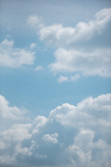 white clouds in the sky against a clear day.