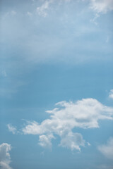white clouds in the sky against a clear day.
