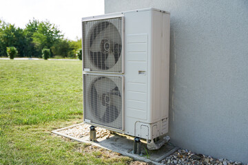 Powerful air conditioning or heat pump outdoor unit with two fans, eco green energy house of future...