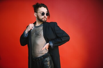 Gay man hold rainbow striped flag isolated on colored background studio portrait. People lifestyle fashion lgbtq concept