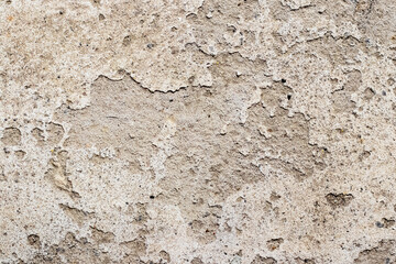 The texture of the plastered wall, from which the plaster fell off in some places