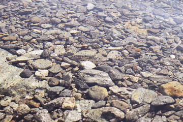 Sea stones on the shore under water
