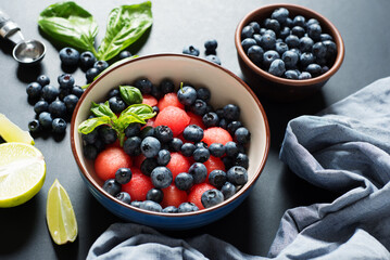 Berry breakfast with watermelon and blueberries on a dark background. Delicious healthy food without cooking