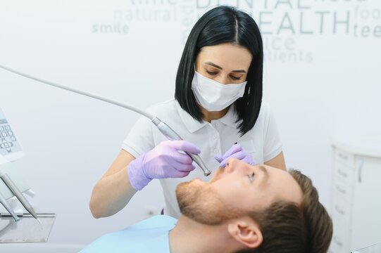 Young man at the dentist. Dental care, taking care of teeth. Picture with copy space for background.