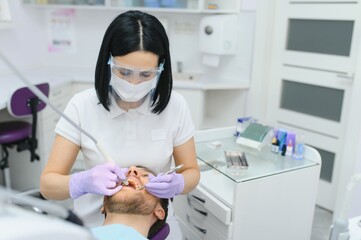 female dentist with male patient at clinic