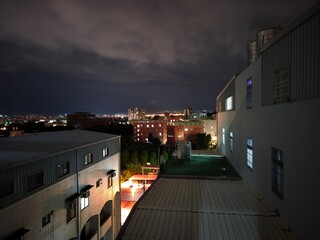 cloudy night in the city illuminated with lights captured from the roof