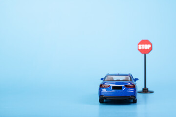 driver education, car at stop road sign on blue background, car accident prevention