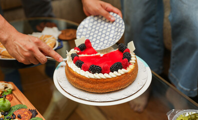 Hands and utensils gather around, embracing the communal spirit of a potluck dinner. Symbolizing unity, sharing, and indulgence as they enjoy a variety of desserts