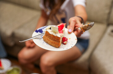 Hands and utensils gather around, embracing the communal spirit of a potluck dinner. Symbolizing unity, sharing, and indulgence as they enjoy a variety of desserts