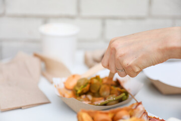 Hands and utensils gather around, embracing the communal spirit of a potluck dinner. Symbolizing unity, sharing, and indulgence as they enjoy a variety of desserts
