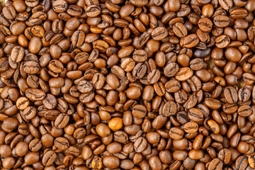 Roasted coffee bean. Masses of falling coffee beans close up. Texture
