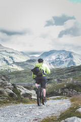 A man riding a mountain bicycle alone
