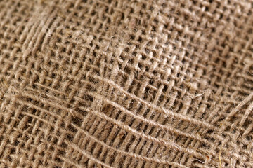 Jute fabric with shadow and natural light. Vintage background. Selective focus