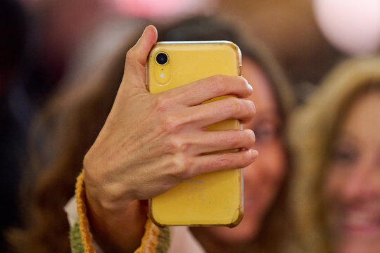woman taking a selfie on yellow phone