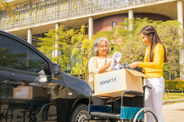 Elderly mother and her asian philanthropist daughter drive to the shelter to donate wheelchairs and...