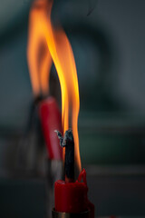 Naklejka premium Red candles are lit for worship and blurred background.