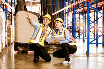 Warehouse workers in safety uniforms caucasian team of workers men and women working in warehouse...