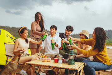 Meeting for fun vacation trips camping trips natural places : Happy group male and female friends singing songs and drinking beer having fun on vacation travel camping holiday trips natural fields.