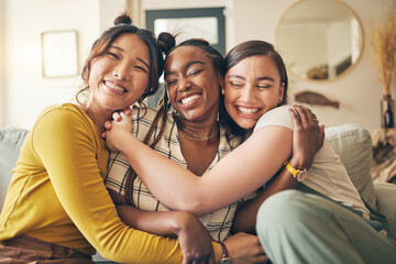 Portrait of a group of women, friends hug on sofa with smile and bonding in living room together in embrace. Hug, love and friendship, girls on couch with diversity, pride and people in home with fun - obrazy, fototapety, plakaty