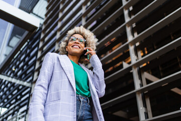 African American business woman using mobile phone in the office 