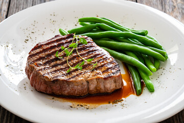 Grilled beef steak on wooden table
