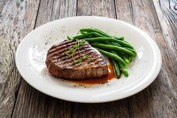 Grilled beef steak on wooden table
