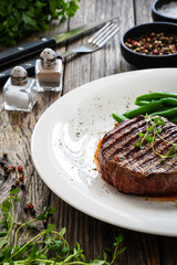 Grilled beef steak on wooden table
