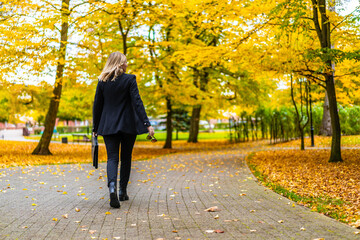 Beautiful woman walking in city park
