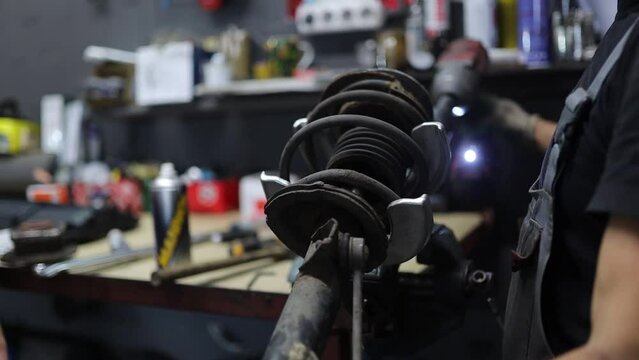 replacement of shock absorbers and springs of a car in a car service.