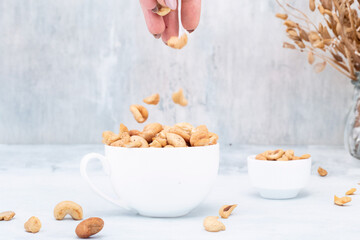 Cashew nut on light background. Healthy grains.