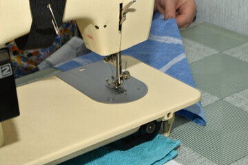 The seamstress is preparing to work behind the sewing machine.