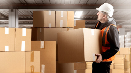Man warehouse employee. Guy with cardboard boxes. Factory warehouse worker. Storekeeper in...