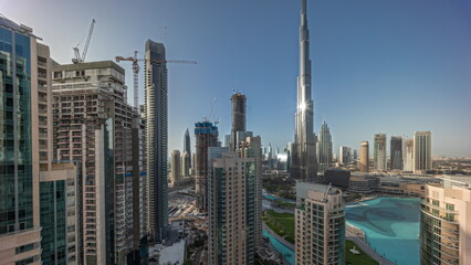 Fototapeta premium Panorama showing Dubai Downtown cityscape with tallest skyscrapers around aerial timelapse.