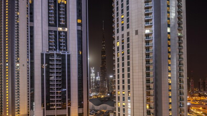 Tallest skyscrapers in downtown dubai located on bouleward street near shopping mall aerial all night timelapse.