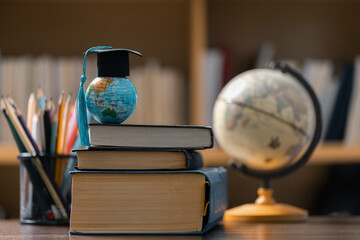 Graduation cap with Earth globe. Concept of global business study, abroad educational, Back to...