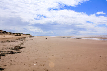 The view of the Formby Beach (Victoria Road Beach) or Formby Dunes in Liverpool, UK at sunny day. City in Merseyside county of North West England. Including the famous sand dunes. Nature, travel scene