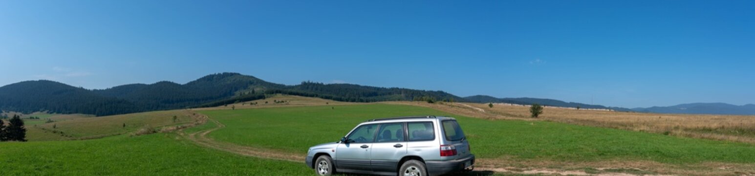 Miercurea Ciuc, Romania- 20 August 2023: Old Subaru Forester SF5 near dirtroad on the top of the hill.