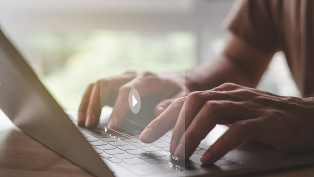 Man hand using laptop computer to watching and live streaming window. Online live stream window. Video streaming on internet concept.
