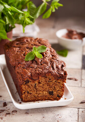 Banana pound cake with dark chocolate and nut butter on the top. Delicious homemade dessert. 