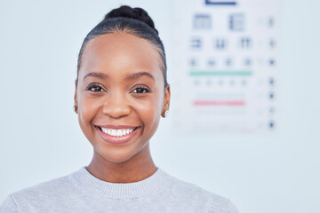 Face, black woman smile and ophthalmology patient in hospital for vision, healthcare or wellness. Portrait, optometrist and happy person in clinic with eye chart for medical professional optician