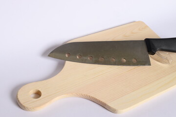 An kitchen knife on wood cutting board isolated