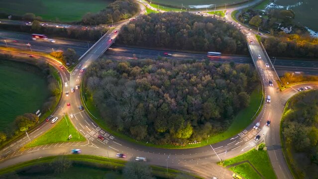 Aerial time-lapse view of M53 J4 Clatterbridge Interchange roundabout at night, Poulton, Wirral, Merseyside, England