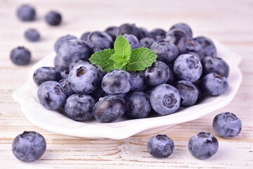 Blueberries in a plate against white background. Close-up.

