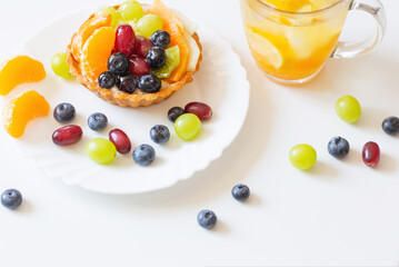 cupcakes with fruits and cold healthy drink on white  table