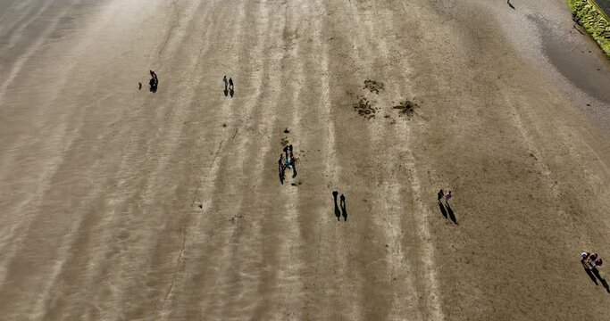 Flying over a wide sandy beach 4k