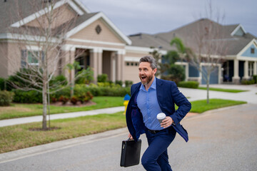 Business man run near house in american neighborhood. Businessman run down street, late for a meeting. Businessman in suit run be success. Running business man. Fast business. Run and late business.