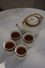 Glasses of Pot Tea in a White Glass and White Pot