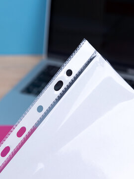 Close up of the blank white A4 paper sheet mockup in crumpled translucent plastic sleeve. Perforated document protector pocket mock up.