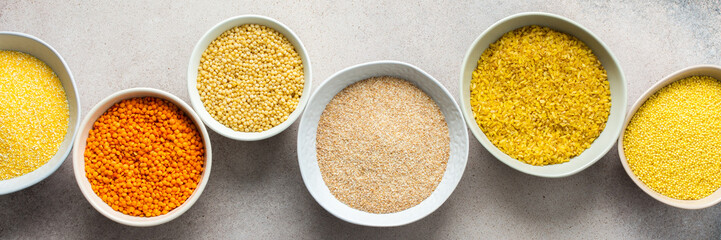 Various grain cereals in bowls banner, top view